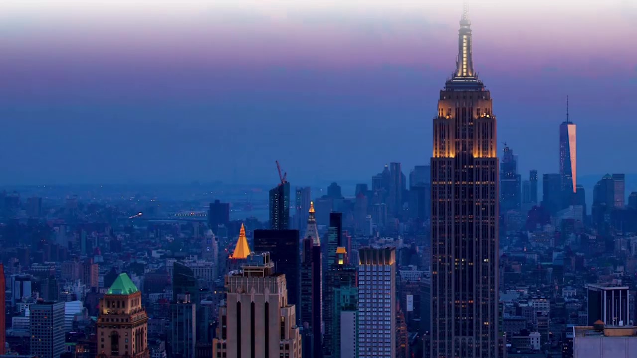 New York City skyline at sunset with skyscrapers reflecting pink and orange hues. Accompanies the Hogan Lovells Employment Horizons report, analyzing key trends shaping the future of work and regulatory developments impacting global employers